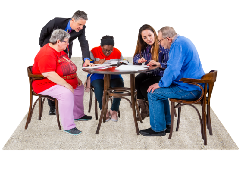 People sitting around a table looking at papers