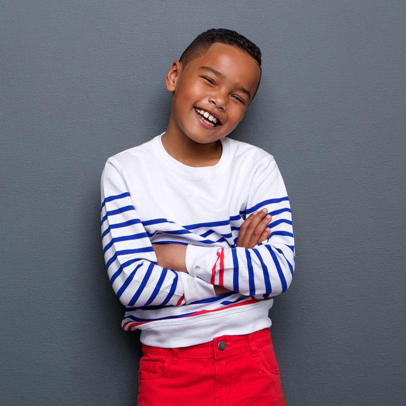 Boy smiling with his arms folded