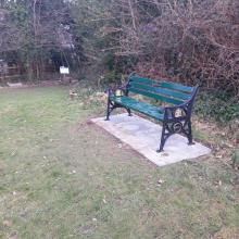 RN6 bench with plaque on paved slabs